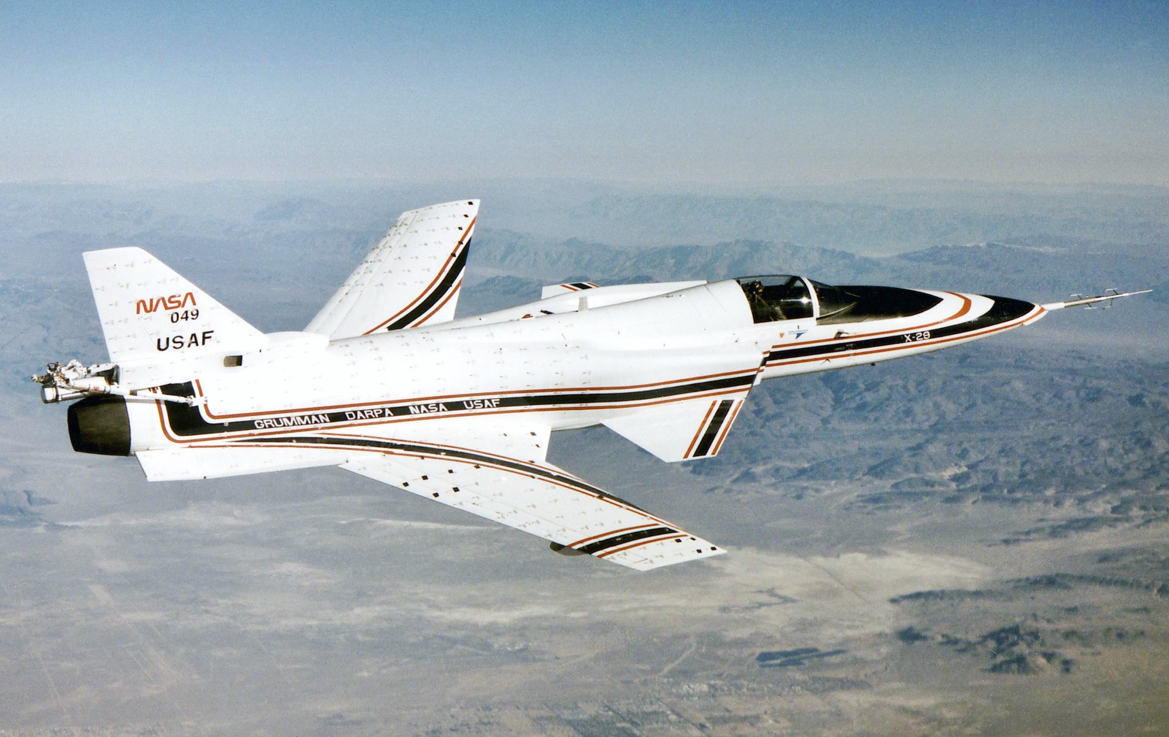 NASA Ames-Dryden X-29 No. 2 in flight over the desert, forward-swept wings and cloth tufts on the surfaces clearly visible